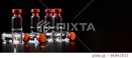 Close-up of medicine for injection in glass vials on a dark background with copy space Close-up of medicine for injection in glass vials on a dark background with copy space 96842815