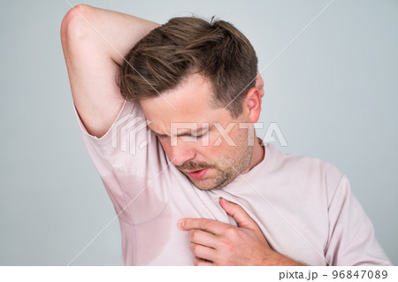 Man with hyperhidrosis sweating very badly under armpit 96847089