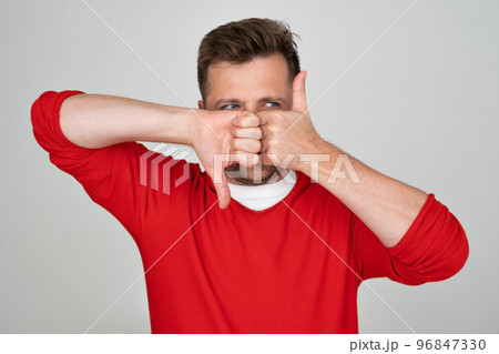 Mature caucasian man making good-bad sign showing thumb up and down. Mature caucasian man making good-bad sign showing thumb up and down. 96847330