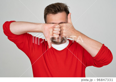 Mature caucasian man making good-bad sign showing thumb up and down. Mature caucasian man making good-bad sign showing thumb up and down. 96847331