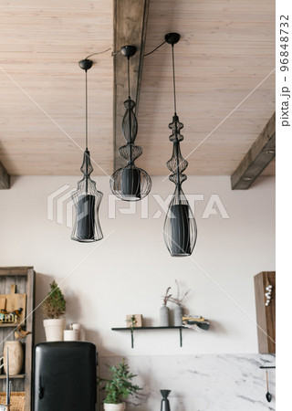 Modern black lamps on the ceiling in the interior of a wooden country house 96848732