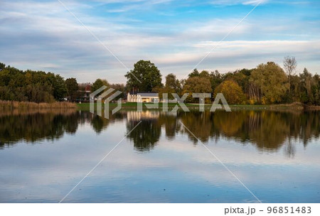 Rotselaar, Flemish Brabant Region, Belgium - Panoramic view over the De Plas water pond with reflecting trees in autumn colors 96851483