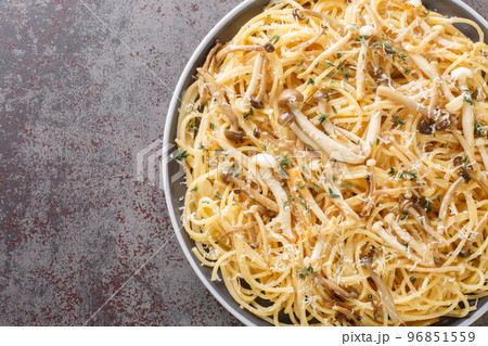 Spaghetti with mushrooms, creamy sauce and thyme closeup on plate. Horizontal top view 96851559