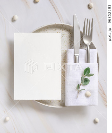 Elegant Table setting with a card decorated with eucalyptus branches top view, Wedding mockup Elegant Table setting with a card decorated with eucalyptus branches top view, Wedding mockup 96852293