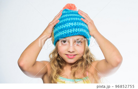 Fall winter season accessory. Free knitting patterns. Knitted hat with pompon. Girl long hair happy face white background. Difference between knitting and crochet. Kid wear warm soft knitted blue hat 96852755