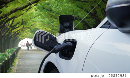Progressive EV car recharging battery at the park surround with people and tree. Progressive EV car recharging battery at the park surround with people and tree. 96852981