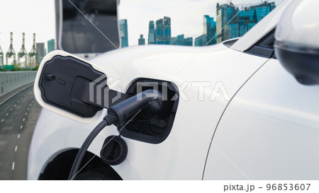 Eco friendly progressive clean energy concept with EV car with cityscape scenery 96853607