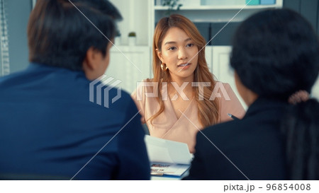 Young female asian candidate tries to impress interviewer by being competent. Young female asian candidate tries to impress interviewer by being competent. 96854008