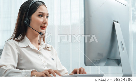 Enthusiastic female operator provide helpful customer service to customer. Enthusiastic female operator provide helpful customer service to customer. 96854280