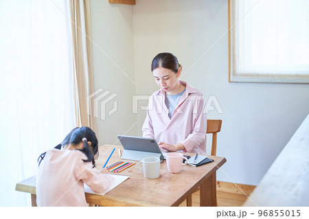 テレワークする母親とお絵描きしている女の子 96855015