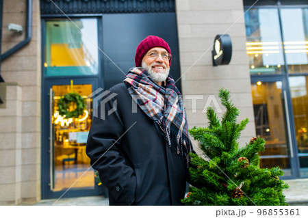trendy old good-looking man walking in sity street at winter near modern building trendy old good-looking man walking in sity street at winter near modern building 96855361