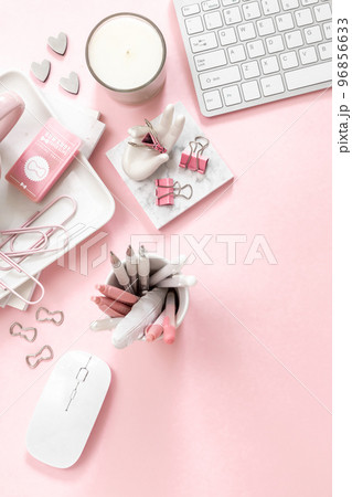 A feminine workspace, keyboard of a computer on pink background with copy space 96856633