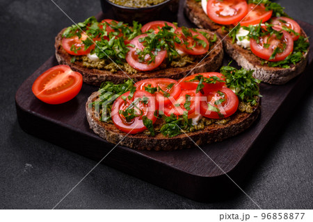 Tasty bruschetta with tomatoes, mozzarella, basil, spices and herbs Tasty bruschetta with tomatoes, mozzarella, basil, spices and herbs 96858877