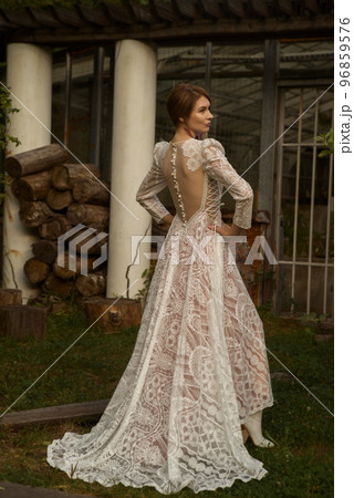 A young beautiful bride in a long boho wedding dress. 96859576