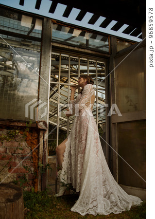 A young beautiful bride in a long boho wedding dress. 96859578