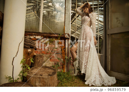 A young beautiful bride in a long boho wedding dress. 96859579