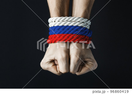 hands tied with red blue white rope 96860419