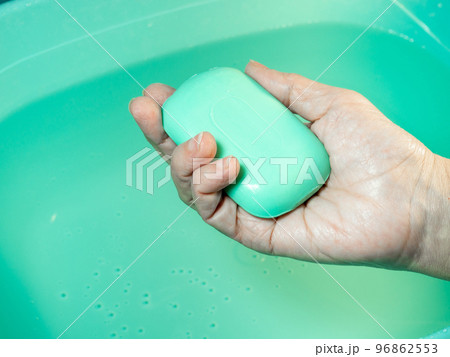 Hand washing. Toilet soap in hand. Green soap. Hand washing. 96862553