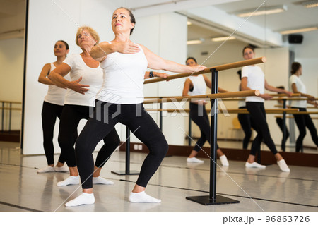 Group of women doing ballet dance moves 96863726