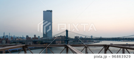 Skyscrapers at dusk of Manhattan as seen from the Brooklyn Bridge Skyscrapers at dusk of Manhattan as seen from the Brooklyn Bridge 96863929