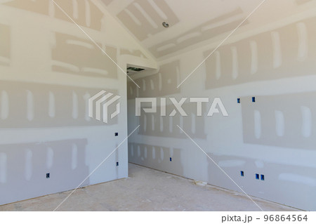 With the completion of plastering drywall newly constructed house is ready for painting With the completion of plastering drywall newly constructed house is ready for painting 96864564