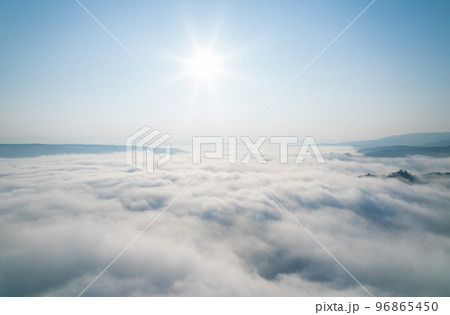 sunny foggy clouds in winter with small mountain view in winter season for create nature content. drone high view for content editing. sunny foggy clouds in winter with small mountain view in winter season for create nature content. drone high view for content editing. 96865450