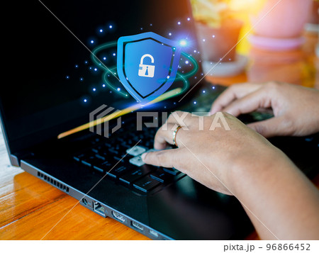 Human hand working on computer and protection icon. Represents the code protection. Security concept and communication technology 96866452