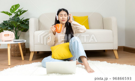 Home lifestyle woman relaxing lying down in living room. 96866593
