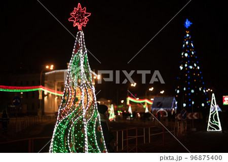 City Gomel Drama Theatre with Christmas illumination and festive Christmas tree on the square 96875400