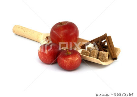 Cinnamon sticks, sugar and anise stars placed in wooden scoop Cinnamon sticks, sugar and anise stars placed in wooden scoop 96875564