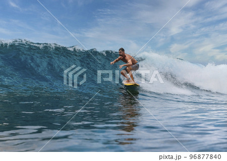 Shirtless male surfer on a wave at sunny day 96877840
