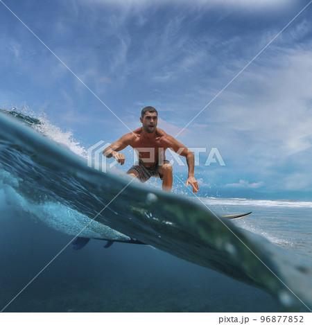 Shirtless male surfer on a wave at sunny day 96877852