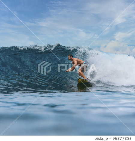 Shirtless male surfer on a wave at sunny day 96877853