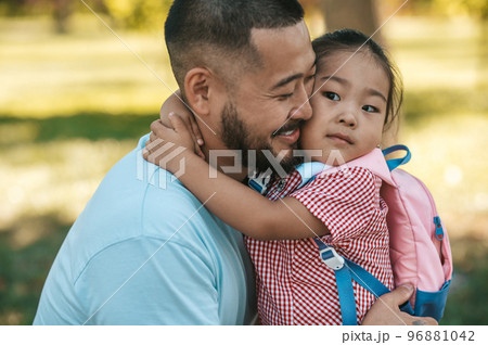 Young man and his daughter in the park after a day together Young man and his daughter in the park after a day together 96881042