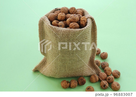 Chufa, tigernut in canvas eco bag on green background with copy space for text. Healthy organic vegan food concept. Tiger nut for flour, milk, traditional homemade drink horchata from Valencia Spain Chufa, tigernut in canvas eco bag on green background with copy space for text. Healthy organic vegan food concept. Tiger nut for flour, milk, traditional homemade drink horchata from Valencia Spain 96883007