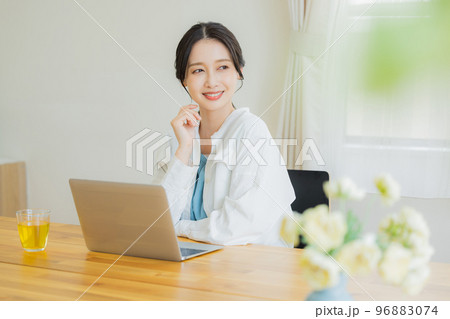 リビングでパソコンを見る女性　 96883074