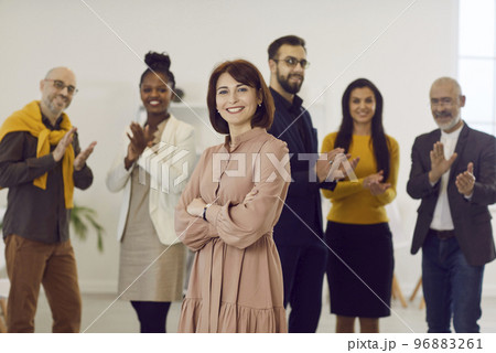 Portrait of confident middle-aged woman on background of her successful business team. 96883261