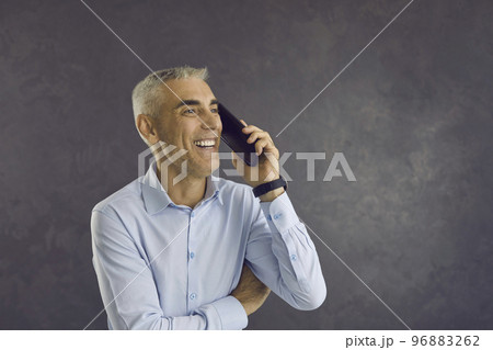 Happy smiling senior man experiencing positive emotions while talking on mobile phone. 96883262