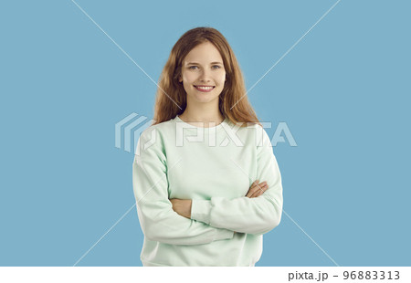 Portrait of beautiful and cute teenage girl in casual clothes on light blue background in studio. 96883313