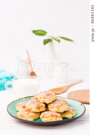 Ready-to-eat cottage cheese cookies on a plate on a wooden table. 96883385
