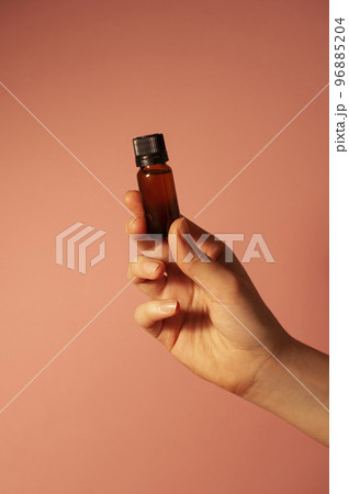 The girl is holding a brown bottle in hand. 96885204