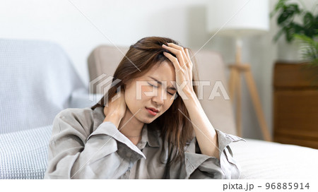 Stressed woman holding her temples with severe problems in her life, Family problems, Pressure from work, Poor financial, Despair in life, discouraged and deeply saddened, Panic attacks. Stressed woman holding her temples with severe problems in her life, Family problems, Pressure from work, Poor financial, Despair in life, discouraged and deeply saddened, Panic attacks. 96885914