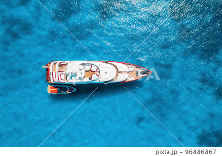 Aerial view of beautiful luxury yacht and boat in blue sea Aerial view of beautiful luxury yacht and boat in blue sea 96886867