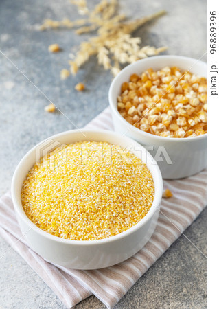 Food gluten free ingredient. Corn groats and seeds over gray stone background. 96889396