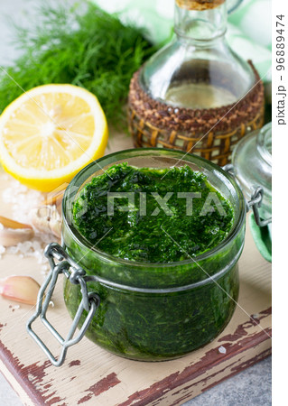 Preserving sauce dill with garlic and olive oil on the kitchen wooden background. 96889474