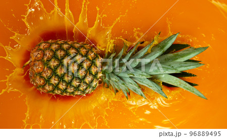 Freeze Motion Shot of Splashing Fresh Pineapple 96889495