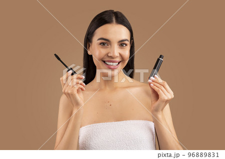Beautiful young woman recommending brand new organic mascara 96889831
