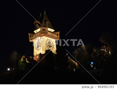 The famous clock tower on Shlossberg hill illuminated by night in Graz, Styria region, Austria. The famous clock tower on Shlossberg hill illuminated by night in Graz, Styria region, Austria. 96890193