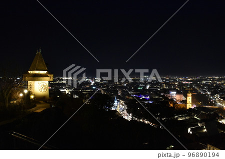 City lights of Graz and the famous clock tower (Grazer Uhrturm) on Shlossberg hill, Graz, Styria region, Austria, by night. Panoramic view. City lights of Graz and the famous clock tower (Grazer Uhrturm) on Shlossberg hill, Graz, Styria region, Austria, by night. Panoramic view. 96890194