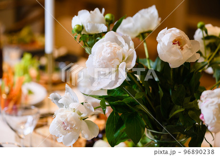 Close-up of peonies flowers at banquet table 96890238